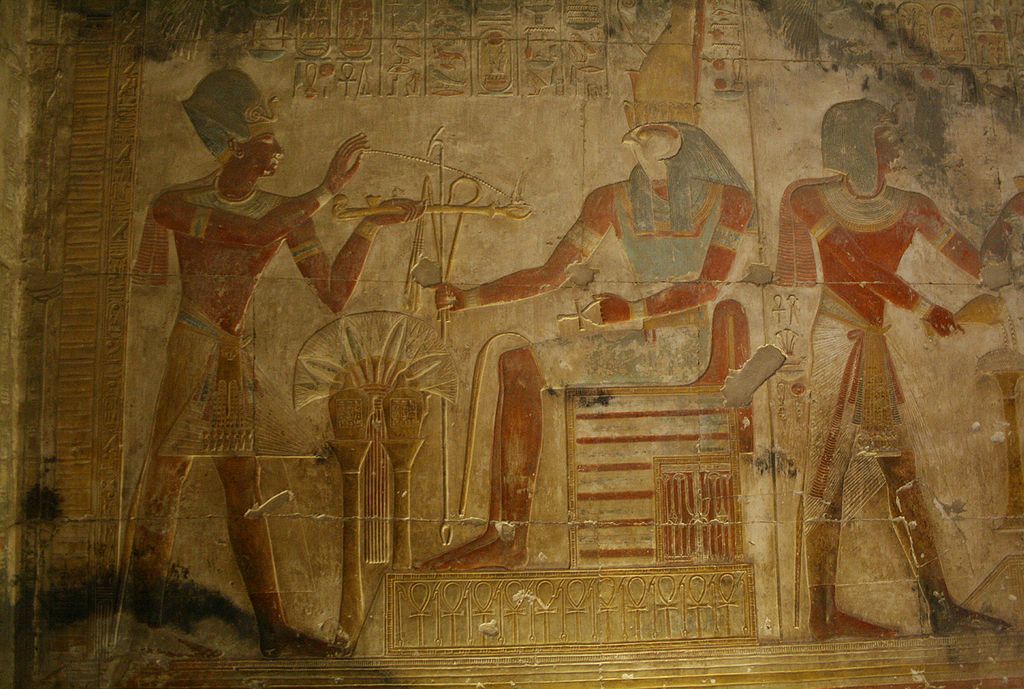 Panel from the Osiris temple: Horus presents royal regalia to a worshipping Pharaoh. By Steve F-E-Cameron, Wikimedia Commons.