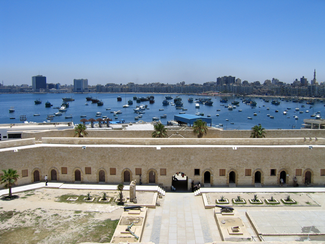 View of the harbour over the outer defensive walls of Fort Qaitbay. By Al Rahalah.